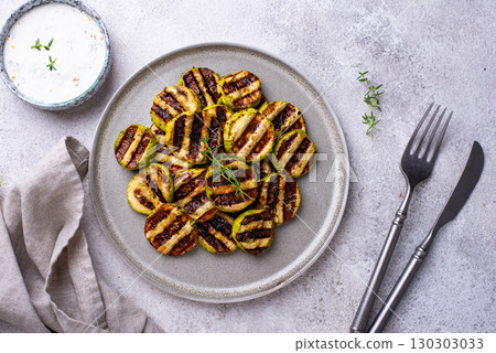 Grilled zucchini with garlic sauce Grilled zucchini with garlic sauce 130303033