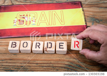 Spain border control concept with national flag and wooden letter blocks on rustic table Spain border control concept with national flag and wooden letter blocks on rustic table 130303198