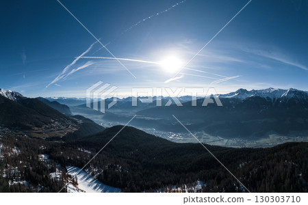 Aerial View of Alpine Valley with River and Mountains in Winter Sunlight. Pano Aerial View of Alpine Valley with River and Mountains in Winter Sunlight. Pano 130303710