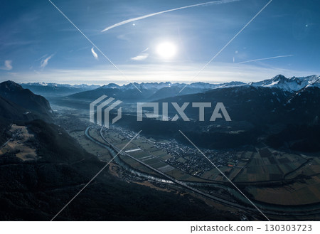 Aerial View of Alpine Valley with River and Mountains in Winter Sunlight. Pano 130303723