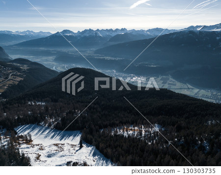 Aerial View of Alpine Valley with River and Mountains in Winter Sunlight. Pano Aerial View of Alpine Valley with River and Mountains in Winter Sunlight. Pano 130303735