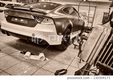 Car Repair Workshop Mechanics Working with Parts 130304171