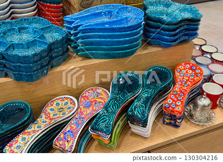 Colorful ceramic spoon rests and decorative bowls. Traditional hand-painted kitchenware, cultural artistry, and vibrant craftsmanship in everyday objects. Colorful ceramic spoon rests and decorative bowls. Traditional hand-painted kitchenware, cultural artistry, and vibrant craftsmanship in everyday objects. 130304216