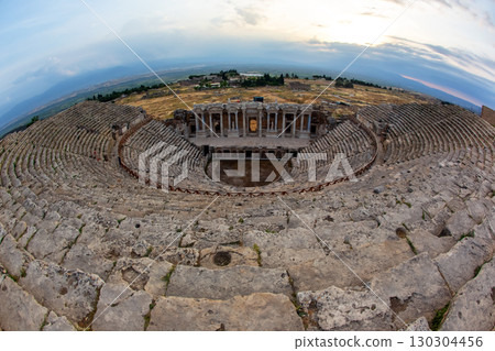 Ancient theater of Baalbek under vibrant sky at dusk showcasing historical architecture 130304456