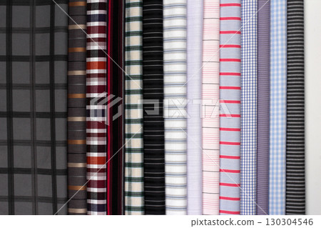 Display of various patterned fabrics in a fabric store with vibrant colors and textures 130304546