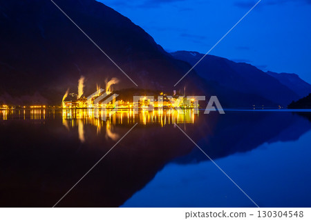 Vibrant industrial landscape along the fjord in Norway with reflections at dusk 130304548