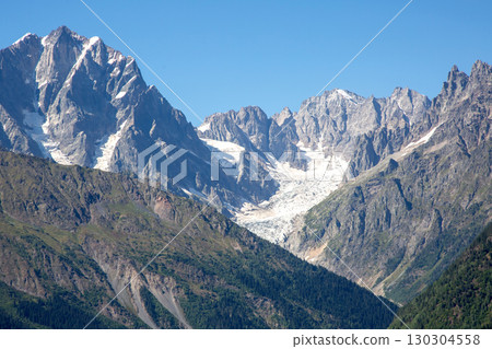 Majestic mountain range with glacier under clear blue sky during daytime Majestic mountain range with glacier under clear blue sky during daytime 130304558