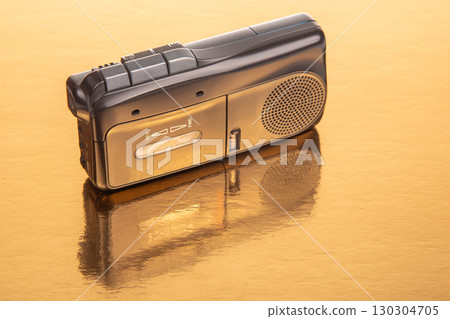 Vintage tape recorder on reflective surface showcasing sound technology from the past 130304705