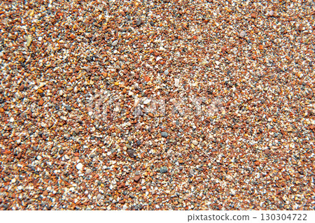 Textured close-up of colorful sand grains on a sunny beach in summer Textured close-up of colorful sand grains on a sunny beach in summer 130304722