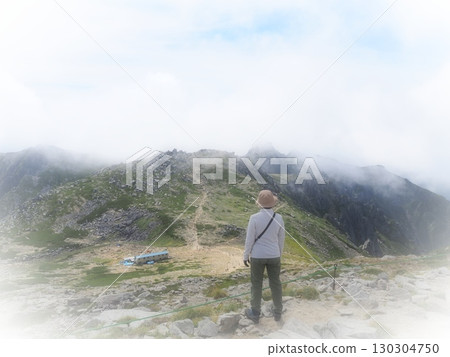 A climber gazing into the mist from the summit (20250822095352) 130304750