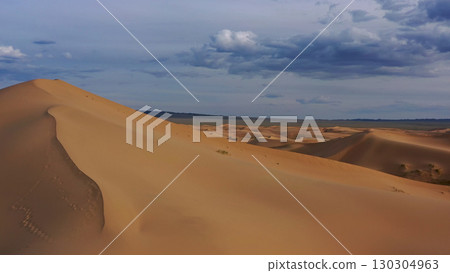 Aerial view of sand dunes in desert at sunset 130304963