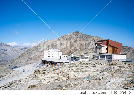 Diavolezza Mountain Hut stands majestically in the Bernina Range, surrounded by stunning alpine scenery. Visitors enjoy hiking and breathtaking views of the Swiss Alps. 130305460