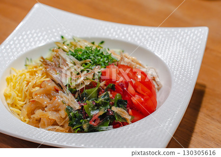 Cold Chinese noodles for dinner with colorful toppings Cold Chinese noodles for dinner with colorful toppings 130305616