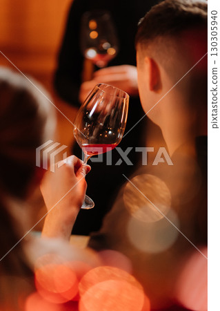Elegant wine tasting moment with romantic candlelight and warm bokeh ambiance Elegant wine tasting moment with romantic candlelight and warm bokeh ambiance 130305940