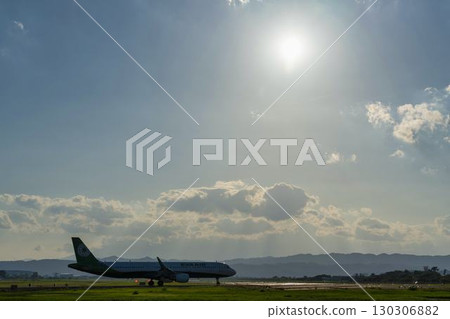 Sendai Airport at dusk, airplane taking off, Natori City, Miyagi Prefecture Sendai Airport at dusk, airplane taking off, Natori City, Miyagi Prefecture 130306882