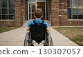 A first-grader in a wheelchair in front of the school entrance, symbolizing accessibility, inclusivity, and equal opportunities in education 130307057