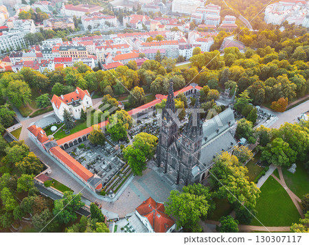Vysehrad Basilica of St. Peter and St. Paul stands majestically in Prague, embraced by lush greenery at sunrise. The serene atmosphere invites reflection amidst the historic architecture. Vysehrad Basilica of St. Peter and St. Paul stands majestically in Prague, embraced by lush greenery at sunrise. The serene atmosphere invites reflection amidst the historic architecture. 130307117