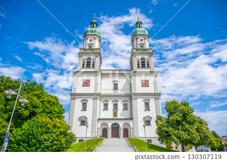 Discover the stunning St. Lorenz Basilica, a baroque masterpiece located in Kempten, Bavaria. Marvel at its twin towers and intricate designs against a bright blue sky. 130307119