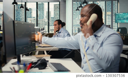 Brokerage company colleagues shocked by Black Swan event shaking global finance, making calls to withdraw money. Hedge fund coworkers see portfolio value drop from market crash 130307536