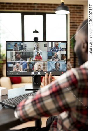 Self employed man hosts online business meeting, sharing project pitch and company vision with investors. Marketing specialist works from home, participates in virtual webinar with diverse individuals Self employed man hosts online business meeting, sharing project pitch and company vision with investors. Marketing specialist works from home, participates in virtual webinar with diverse individuals 130307557