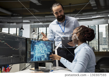 Smiling manager pleased by trader running AI technology on computer to do automated trading. Happy supervisor satisfied with worker applying deep learning algorithms to analyze complex market data 130307593