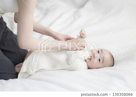 Young mother taking care of her baby Young mother taking care of her baby 130308066
