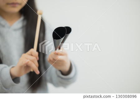 Child practicing agogobel 130308096