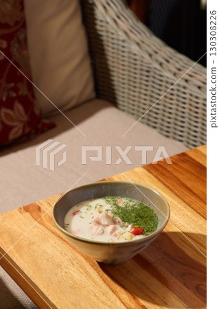 A Delicious Bowl of Creamy Soup Placed on a Beautiful Wooden Table for Enjoyment A Delicious Bowl of Creamy Soup Placed on a Beautiful Wooden Table for Enjoyment 130308226