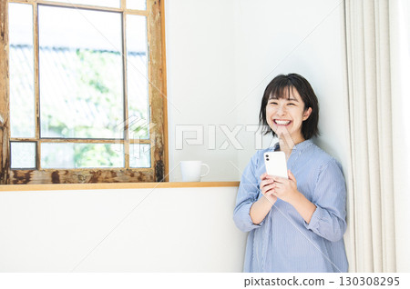 Woman holding a smartphone Woman holding a smartphone 130308295