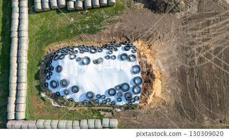 Farm storage practice utilizing tires for silage protection during summer months in a rural agricultural setting Farm storage practice utilizing tires for silage protection during summer months in a rural agricultural setting 130309020