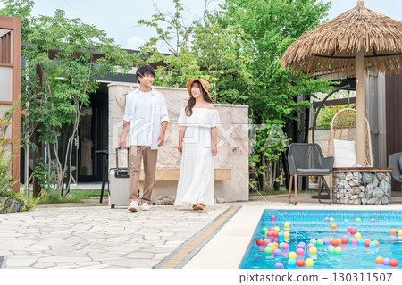 Young Asian couple walking by the poolside of a resort hotel (travel, honeymoon, vacation) Young Asian couple walking by the poolside of a resort hotel (travel, honeymoon, vacation) 130311507