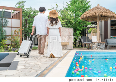 Young Asian couple walking by the poolside of a resort hotel (travel, honeymoon, vacation) 130311513