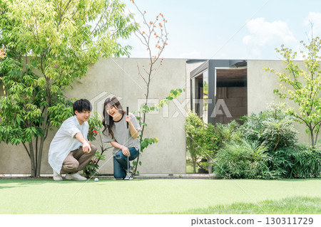 Couple playing putt-putt golf 130311729