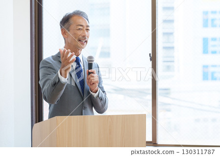 Senior businessman giving a presentation 130311787