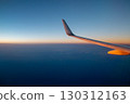 Sunset, sea, sky and wings seen from the airplane window 130312163