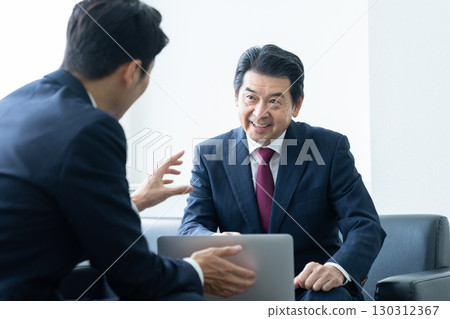 Senior businessman receiving sales Senior businessman receiving sales 130312367