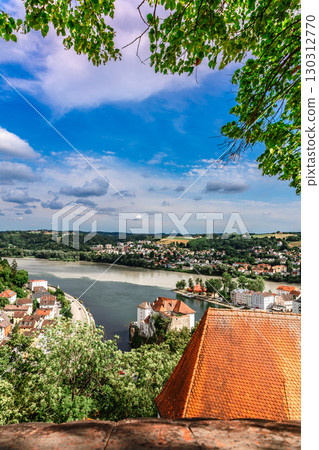 Panoramic view of Passau. Aerial skyline of old town from Veste Oberhaus castle . Confluence of three rivers Danube, Inn, Ilz, Bavaria, Germany. Vertical photo Panoramic view of Passau. Aerial skyline of old town from Veste Oberhaus castle . Confluence of three rivers Danube, Inn, Ilz, Bavaria, Germany. Vertical photo 130312770