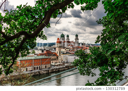 Panoramic view of Passau. View through tree branches. Aerial skyline of old town with beautiful reflection in Danube river, Bavaria, Germany. High quality photo 130312789