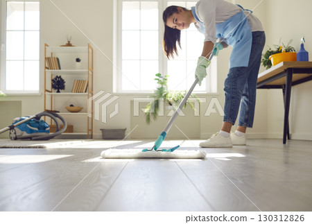 Housewife Mopping the Living Room Floor Housewife Mopping the Living Room Floor 130312826