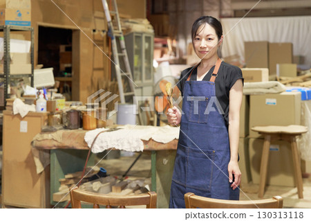 Portrait of a female staff member working in a woodworking shop Portrait of a female staff member working in a woodworking shop 130313118
