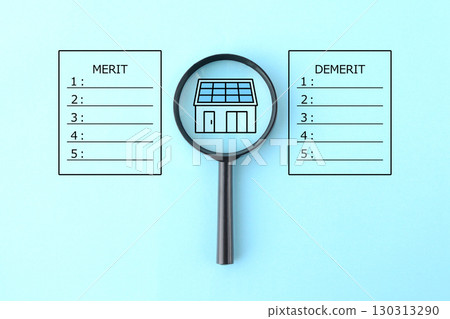 Image of a magnifying glass examining the advantages and disadvantages of installing solar panels on a home 130313290