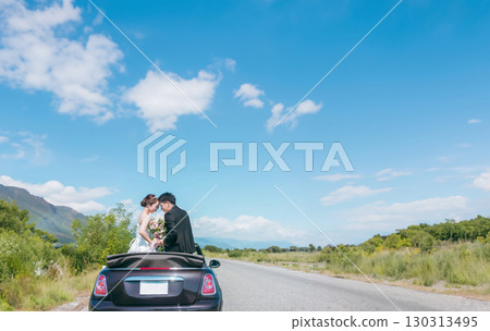 Bride and groom taking wedding photos with their beloved car (convertible) 130313495