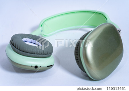Modern wireless headphones lying on white background Modern wireless headphones lying on white background 130313661