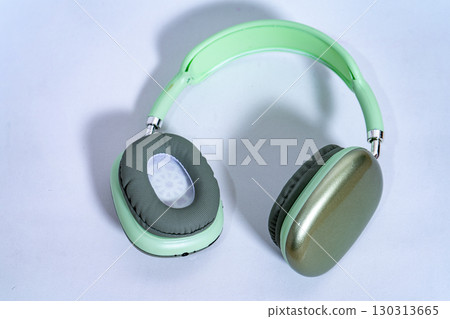 Modern wireless headphones lying on white background 130313665