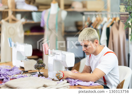 man tailor sews on a machine man tailor sews on a machine 130313756