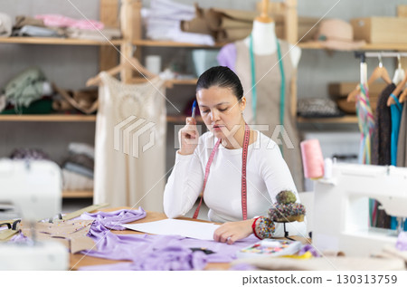 Female Dressmaker Takes Order by Phone 130313759