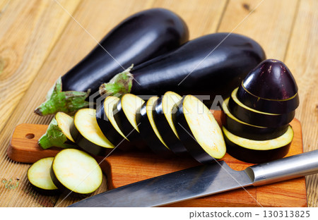 Sliced aubergine on wooden table 130313825