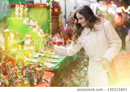 Woman choosing Christmas decorations 130313863