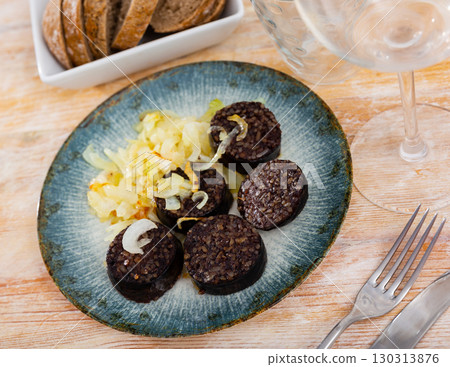 Morcilla con cebolla - traditional Spanish sausage from blood closeup Morcilla con cebolla - traditional Spanish sausage from blood closeup 130313876
