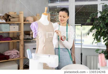 Asian woman working with mannequin in workshop Asian woman working with mannequin in workshop 130314248